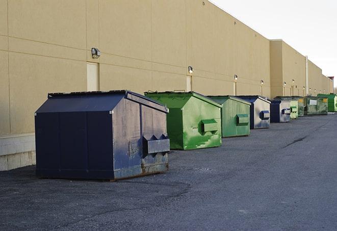 a row of large construction dumpsters on-site in Apple Springs TX